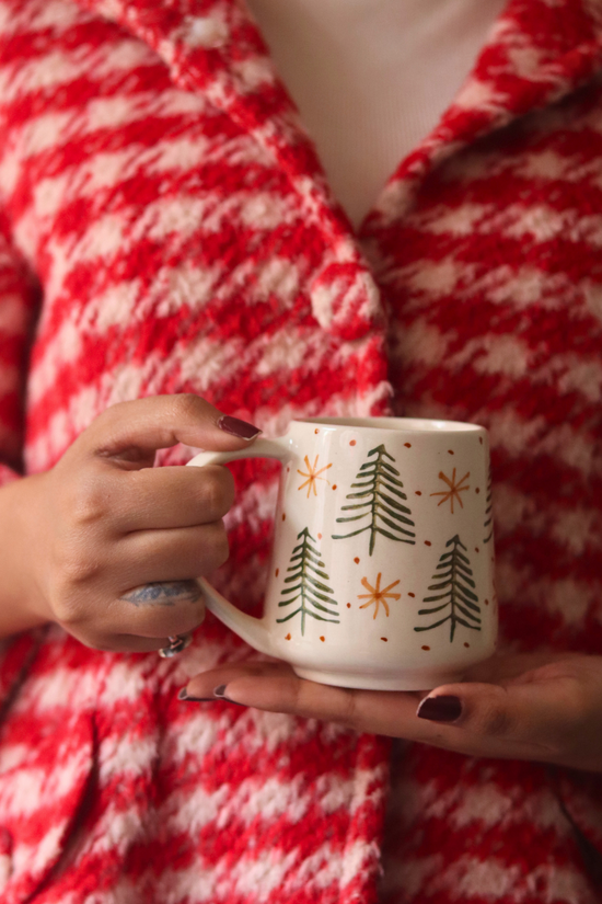 Handmade ceramic X-mas mug in hand