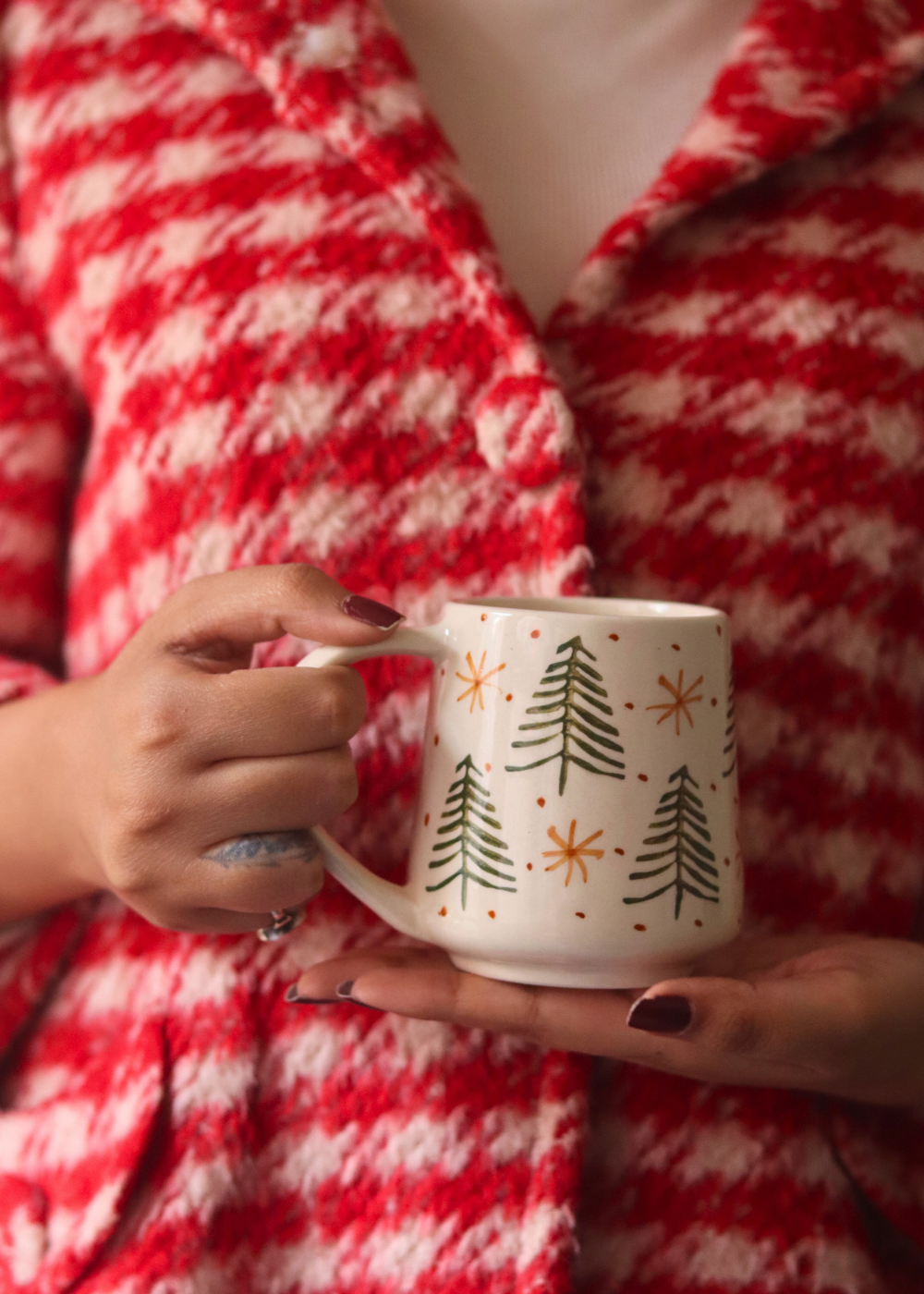 Handmade ceramic X-mas mug in hand