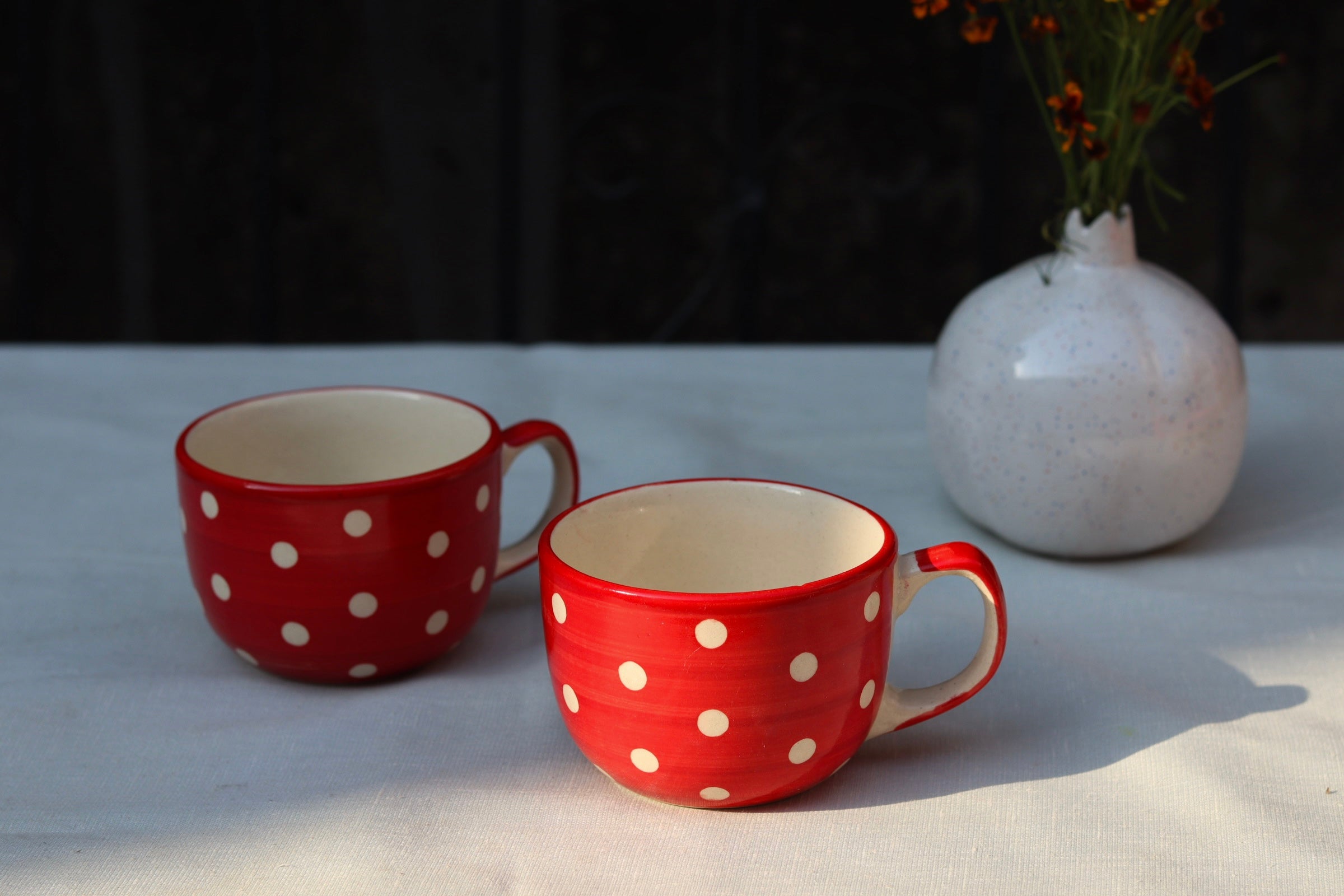 Two handmade ceramic red & white coffee mugs 