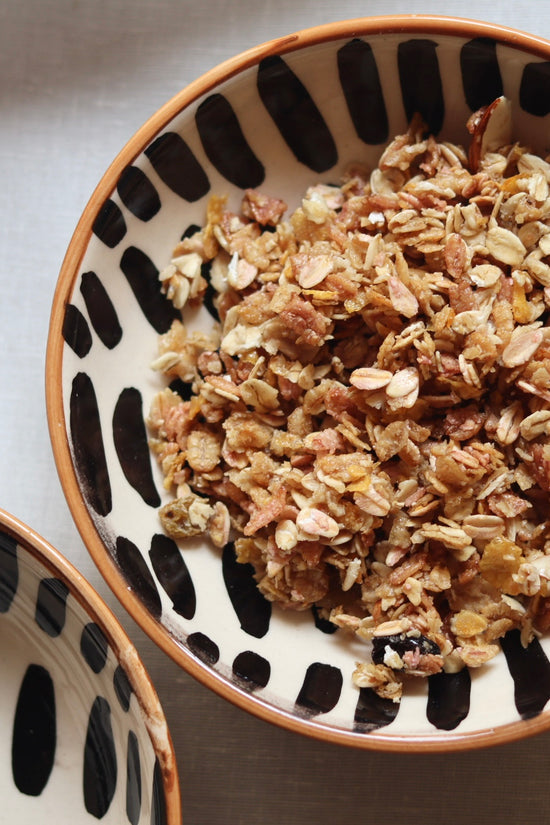 handmade striped cereal bowl with delicious dessert