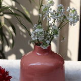 Ceramic pink flower vase with white flowers