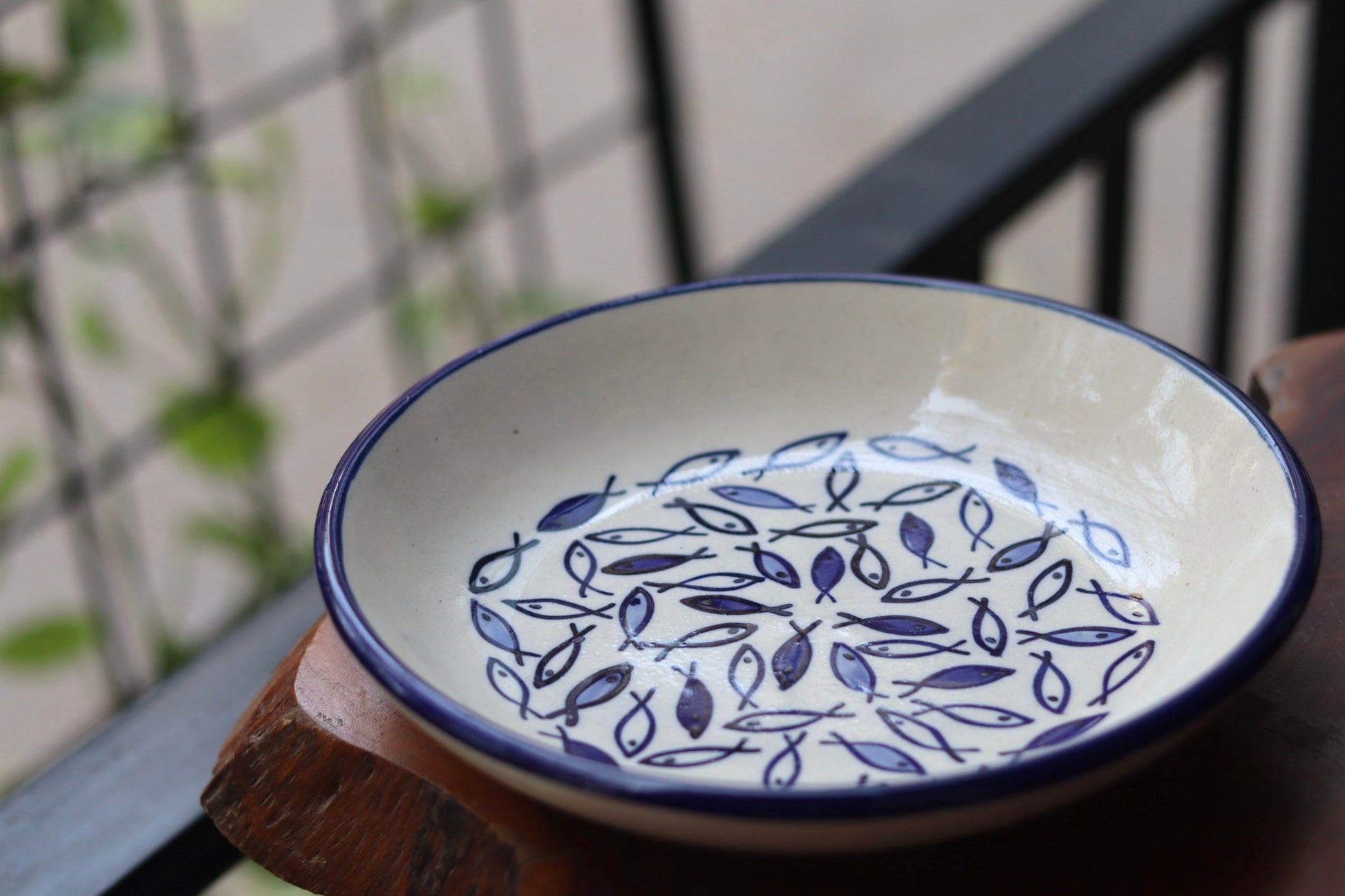 Ceramic fish pasta plate on wooden surface