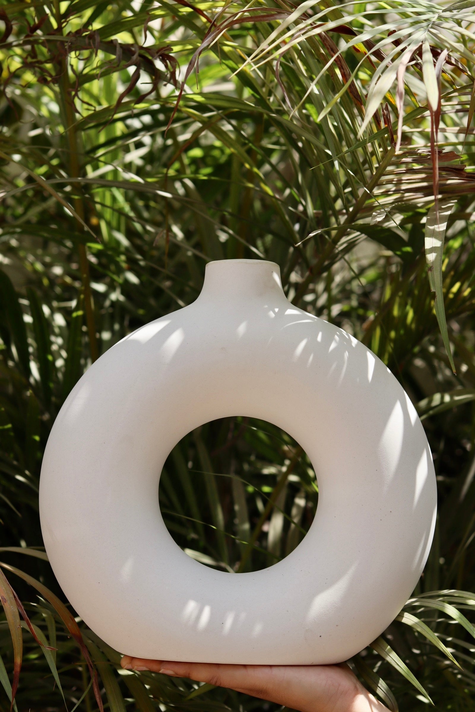 white donut vase made by ceramic 