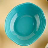 Basic teal bowl on a plain surface