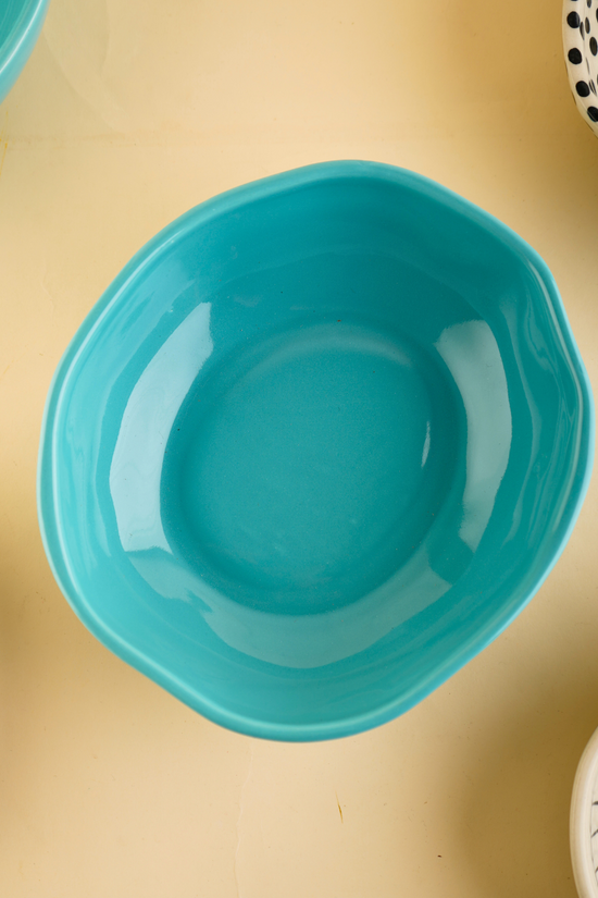Basic teal bowl on a plain surface