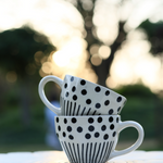 Black lines meet polka coffee mug in a garden