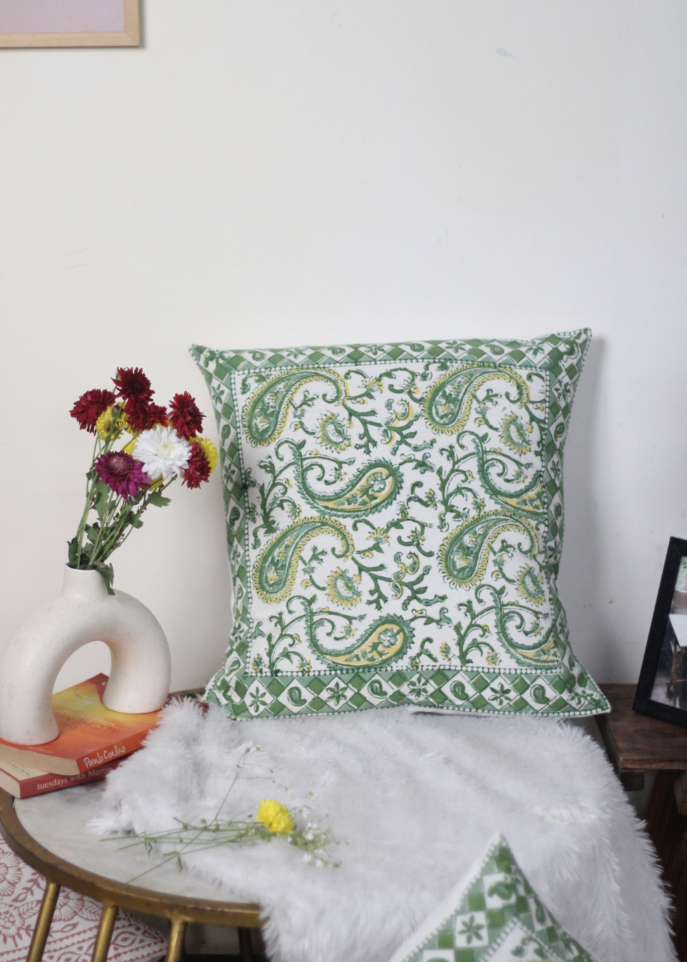 Green paisley cushion cover on chair