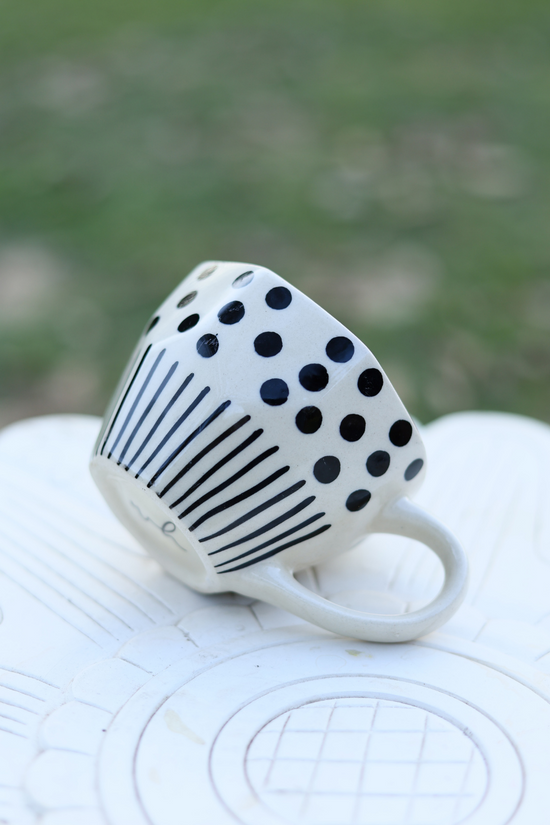 White and black coffee mug on a white surface