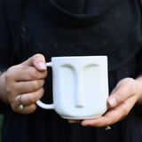 Drinkware handmade white face coffee mug in hand