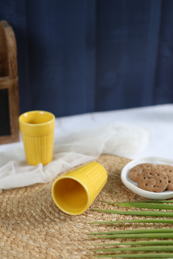 Yellow handmade kulhads with cookies