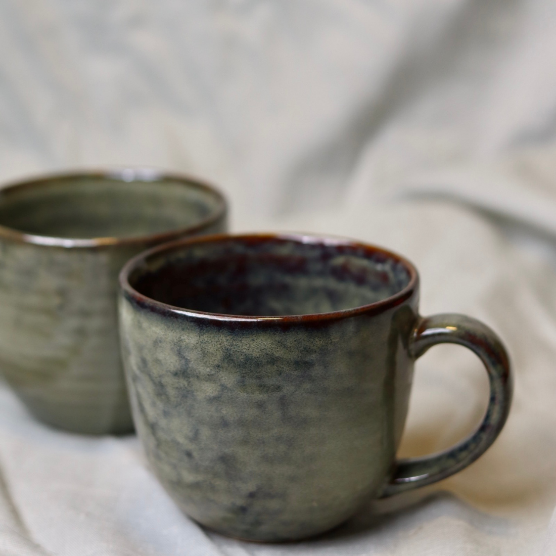 Closeup shot of round olive mugs 
