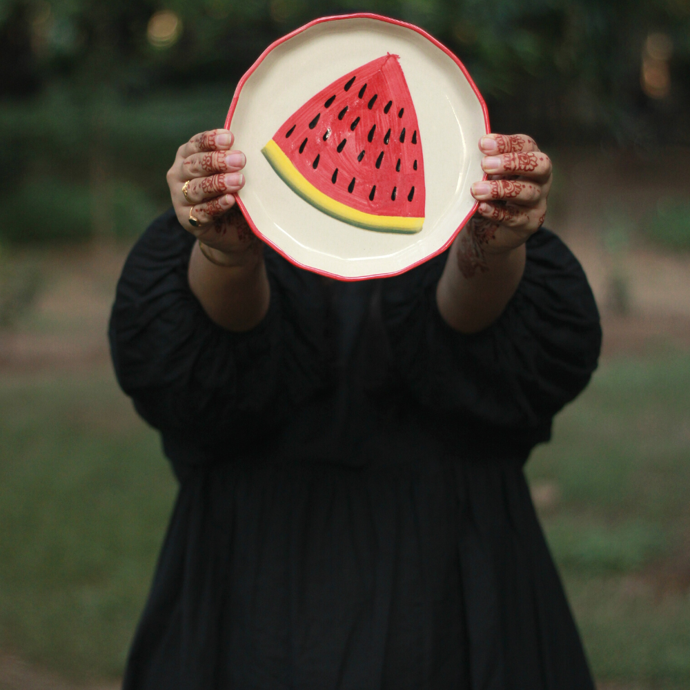 Handmade ceramic watermelon plate in hand 