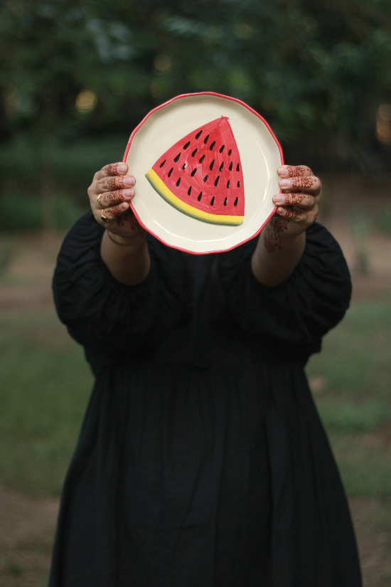 Handmade ceramic watermelon plate in hand 