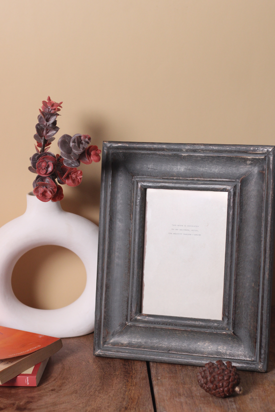 Wooden photo frame on table 