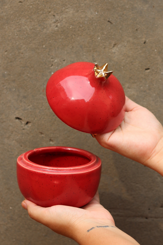Anar jar red color in a hand