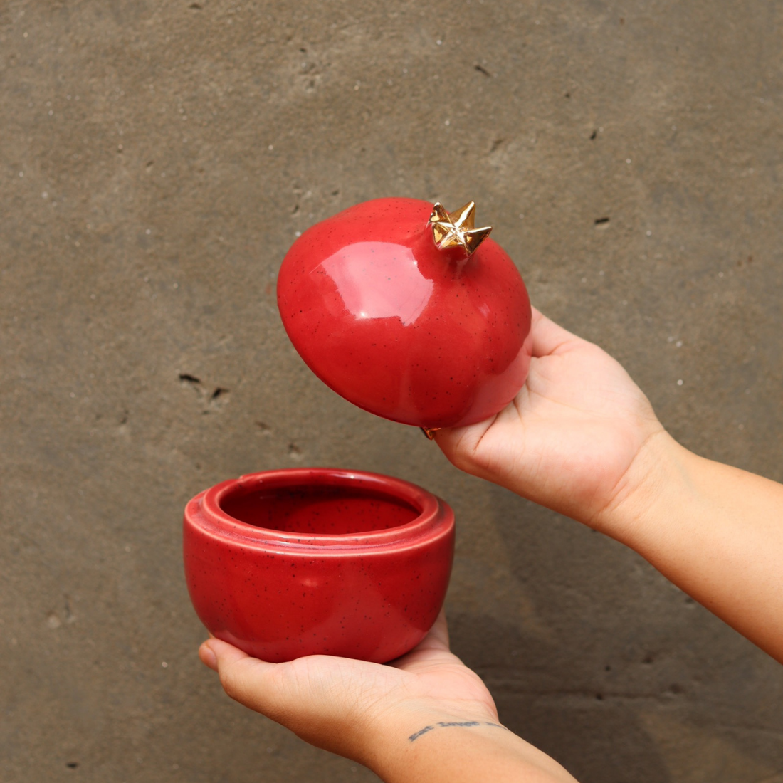 Anar jar red color in a hand