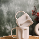 Two handmade ceramic face coffee mugs 