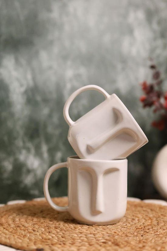 Two handmade ceramic face coffee mugs 