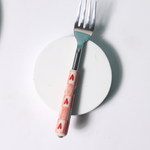 Chequered heart fork on white surface