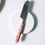 Chequered heart knife on white surface