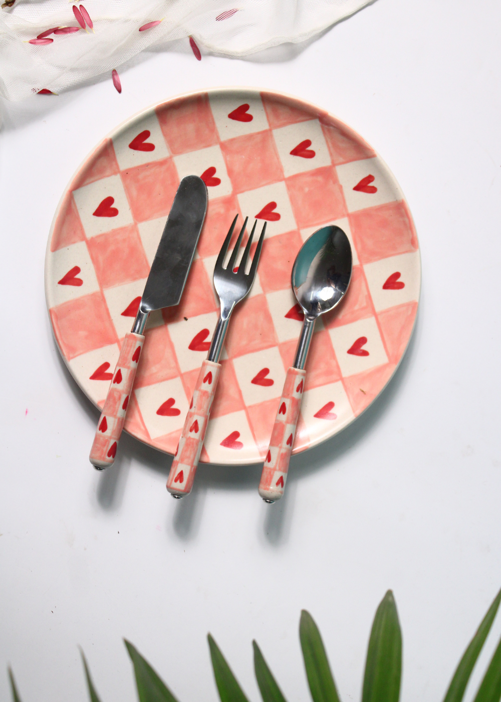 Chequered heart cutlery on plate
