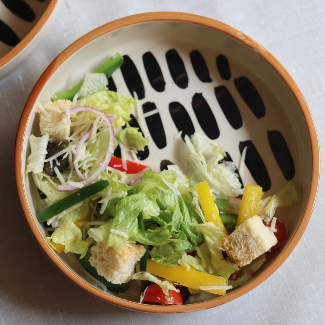 Handmade ceramic salad bowl with salad