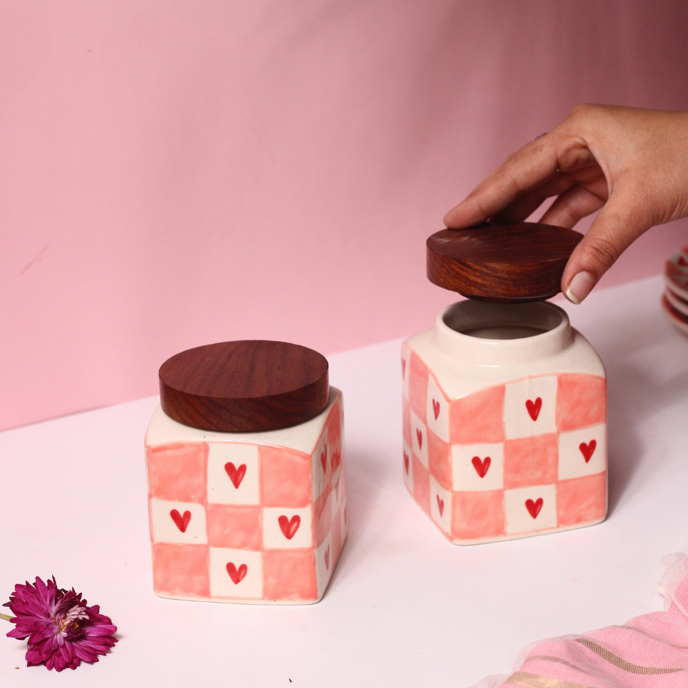 Chequered heart jars and lid in a hand