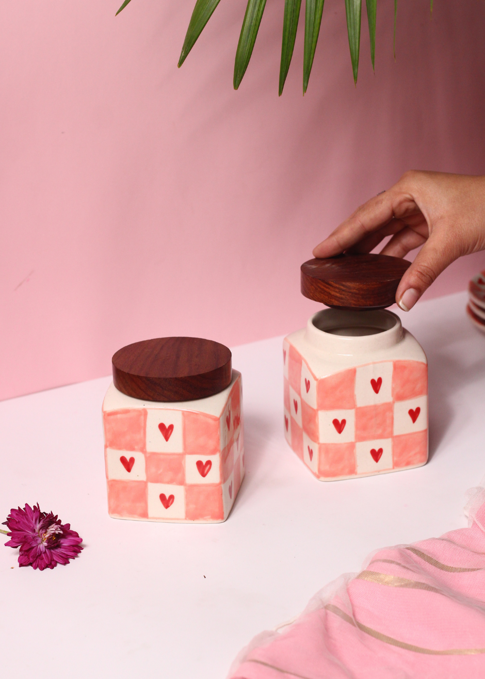 Chequered heart jars and lid in a hand