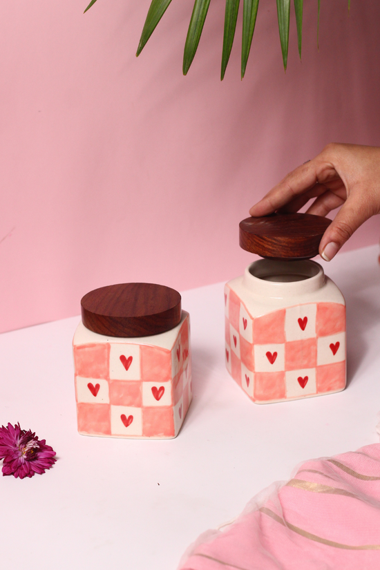 Chequered heart jars and lid in a hand