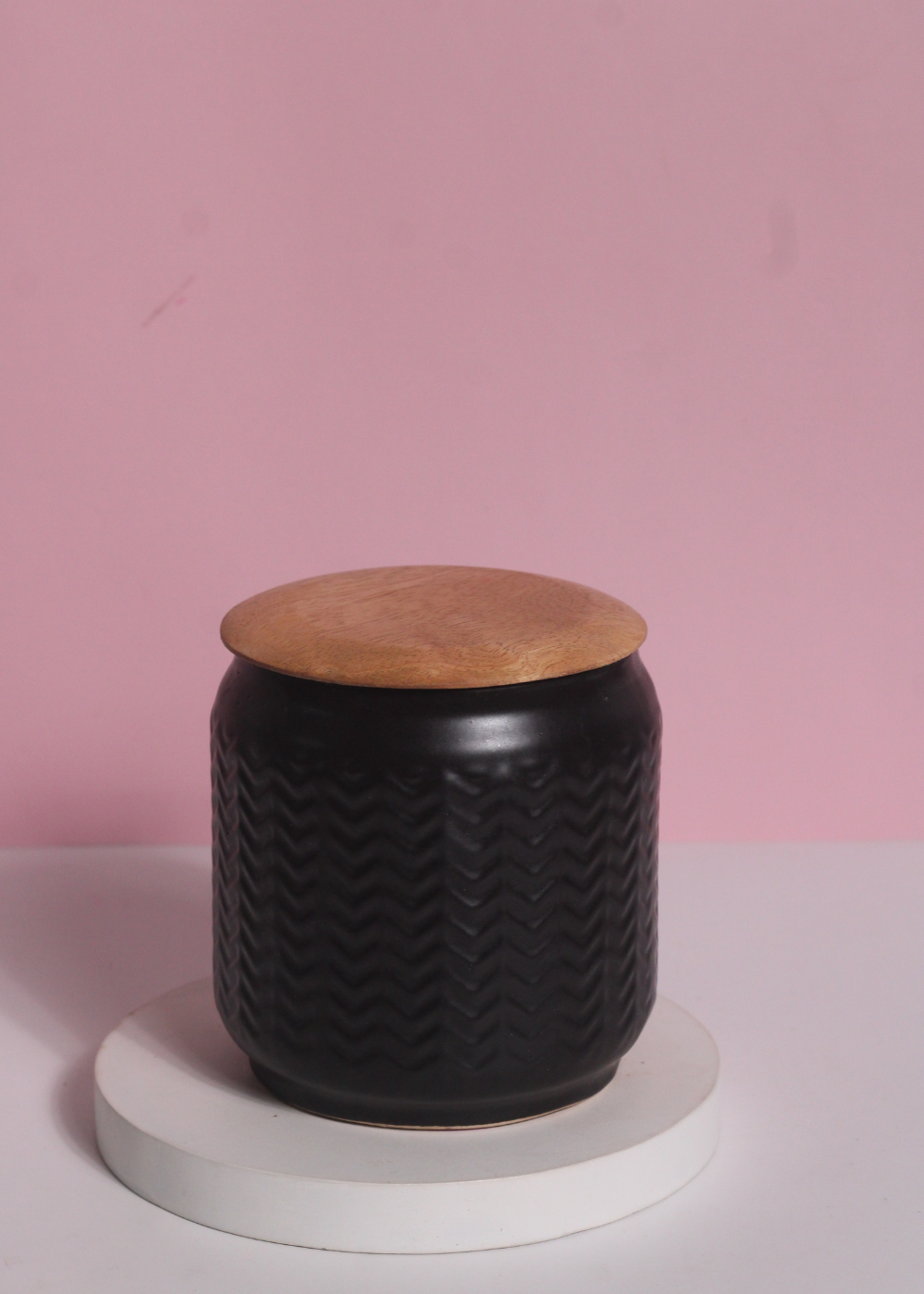 Black storage jar with wooden lid