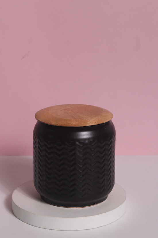 Black storage jar with wooden lid