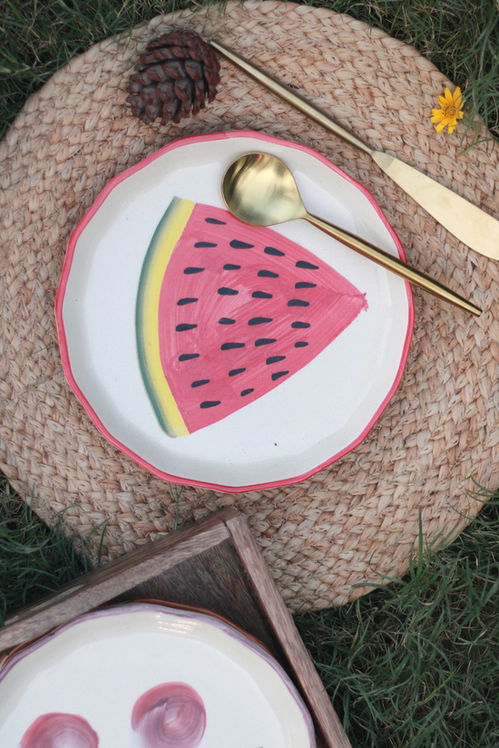 Two handmade ceramic plates with cutlery 