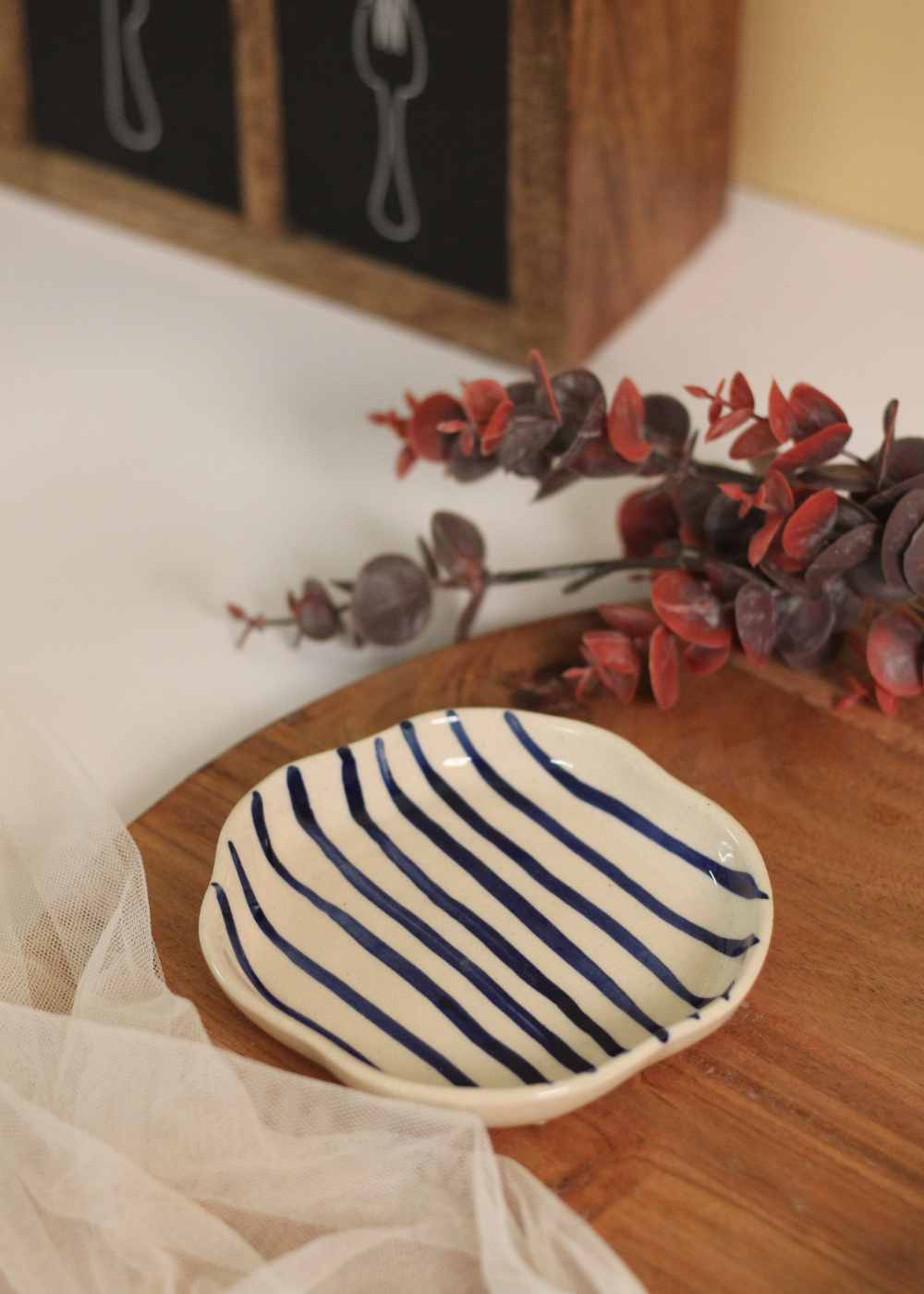 Blue lined dessert plate on wooden surface