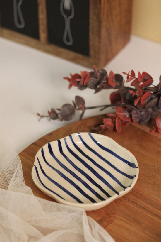 Blue lined dessert plate on wooden surface