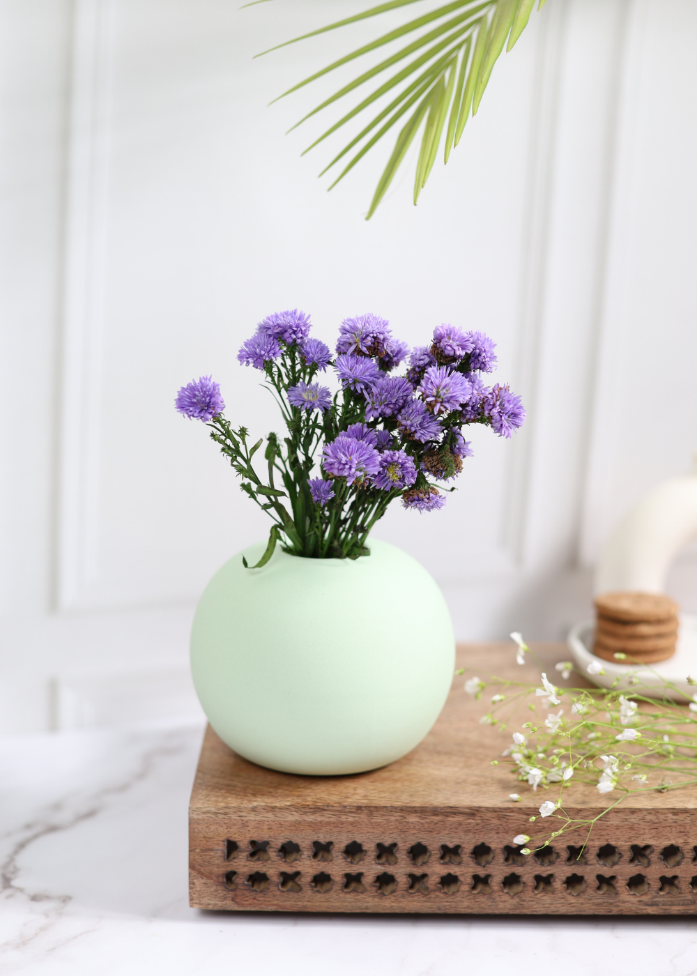 Light green round planter with flowers 