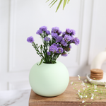 Light green round planter with flowers 