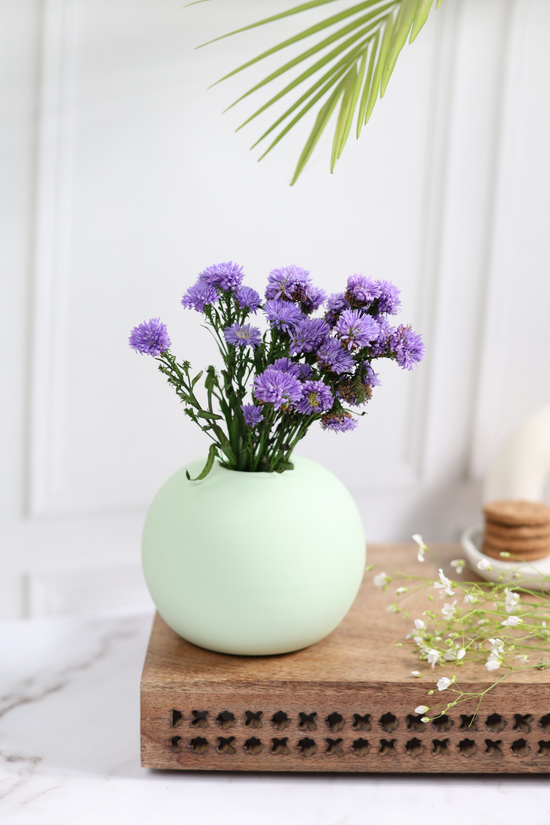 Light green round planter with flowers 