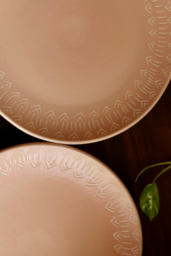 Blush pink carved dinner plates closeup shot
