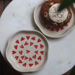 Handmade red heart plates with dessert