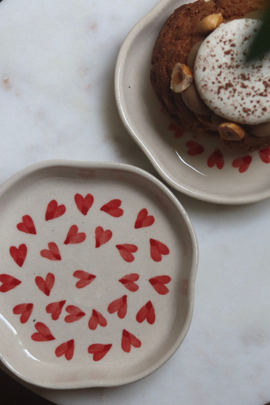 Handmade red heart plates with dessert
