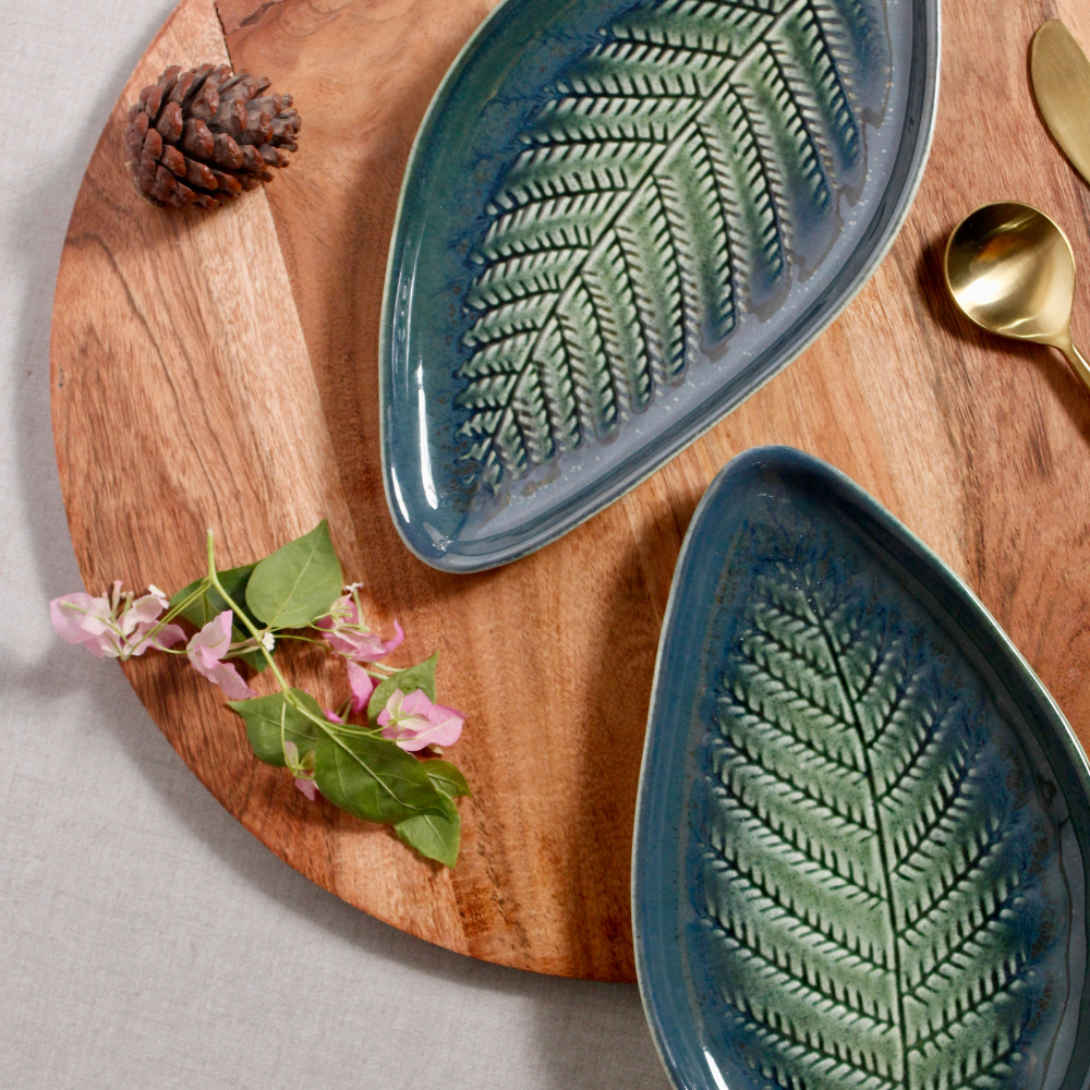 Leaf engraved platter on wooden surface