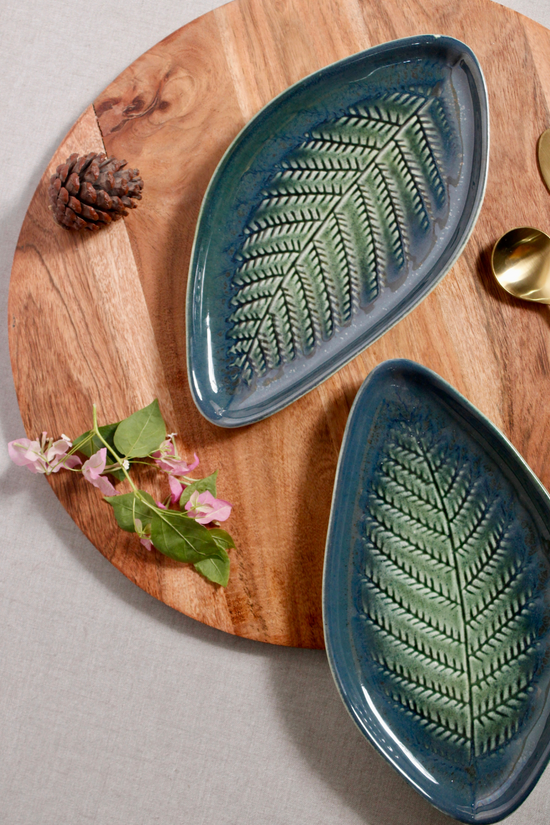 Leaf engraved platter on wooden surface