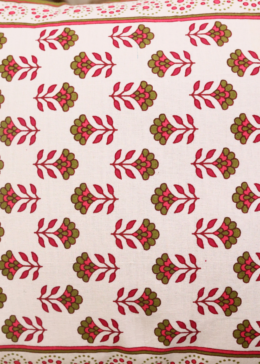 Closeup shot of pink & green motifs cushions