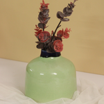 Green round vase with flowers