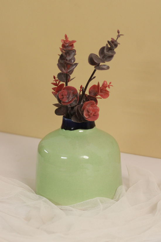 Green round vase with flowers