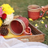 Coffee mug laying on the surface with flowers