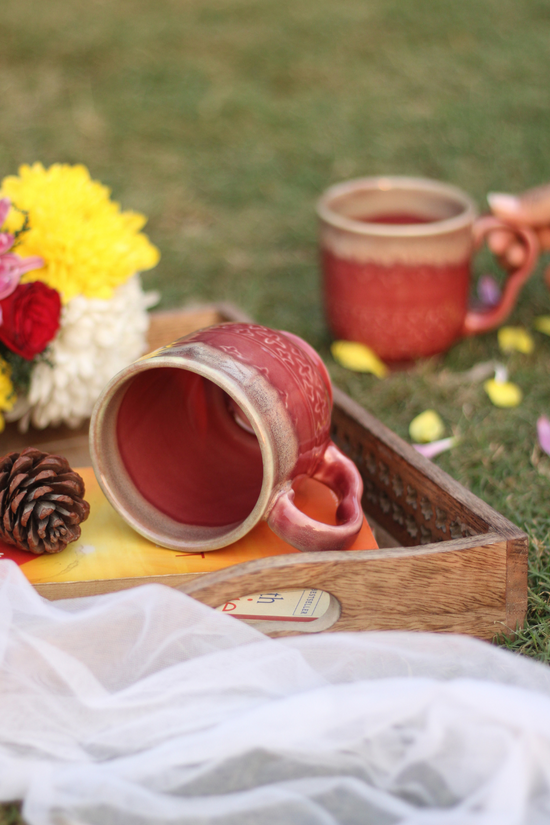 Coffee mug laying on the surface with flowers