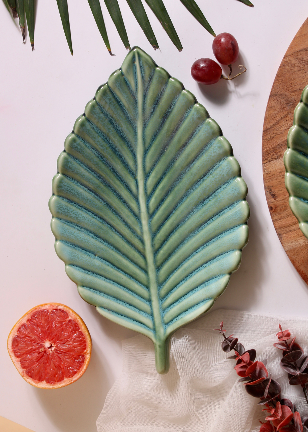Top shot of leaf platter with orange and berries