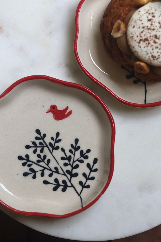 BIrdie handmade plate on a white surface