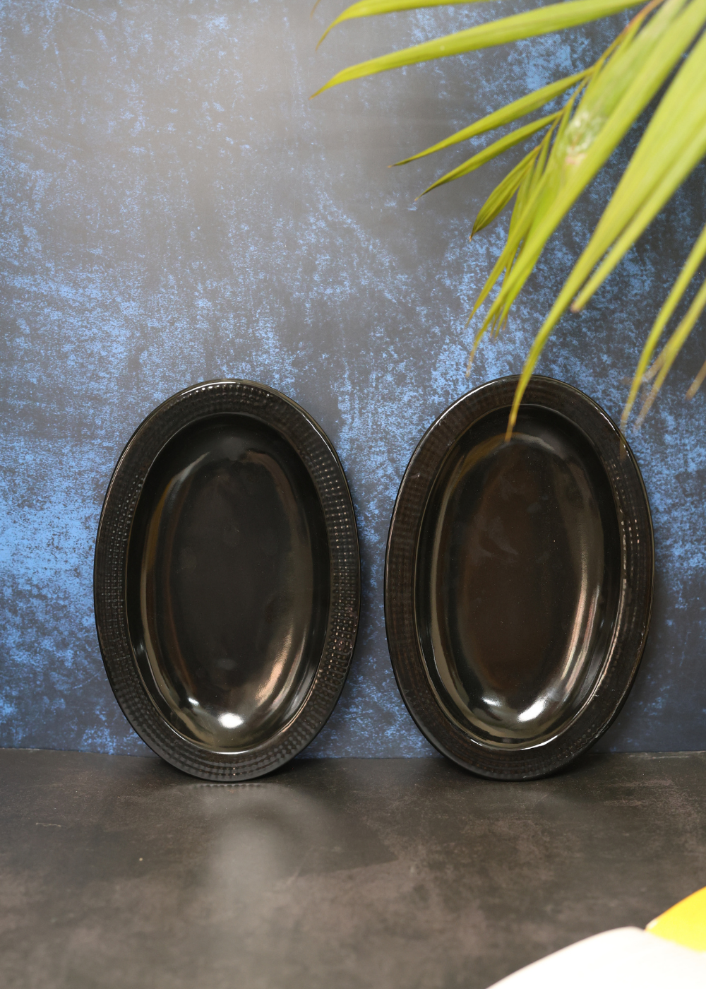 Black oval bowl standing with wall